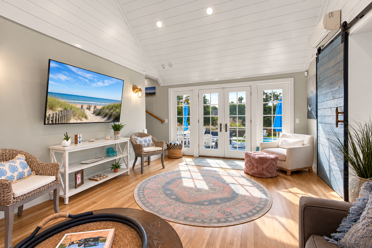 Sun-filled coastal living room with French doors and vaulted ceilings