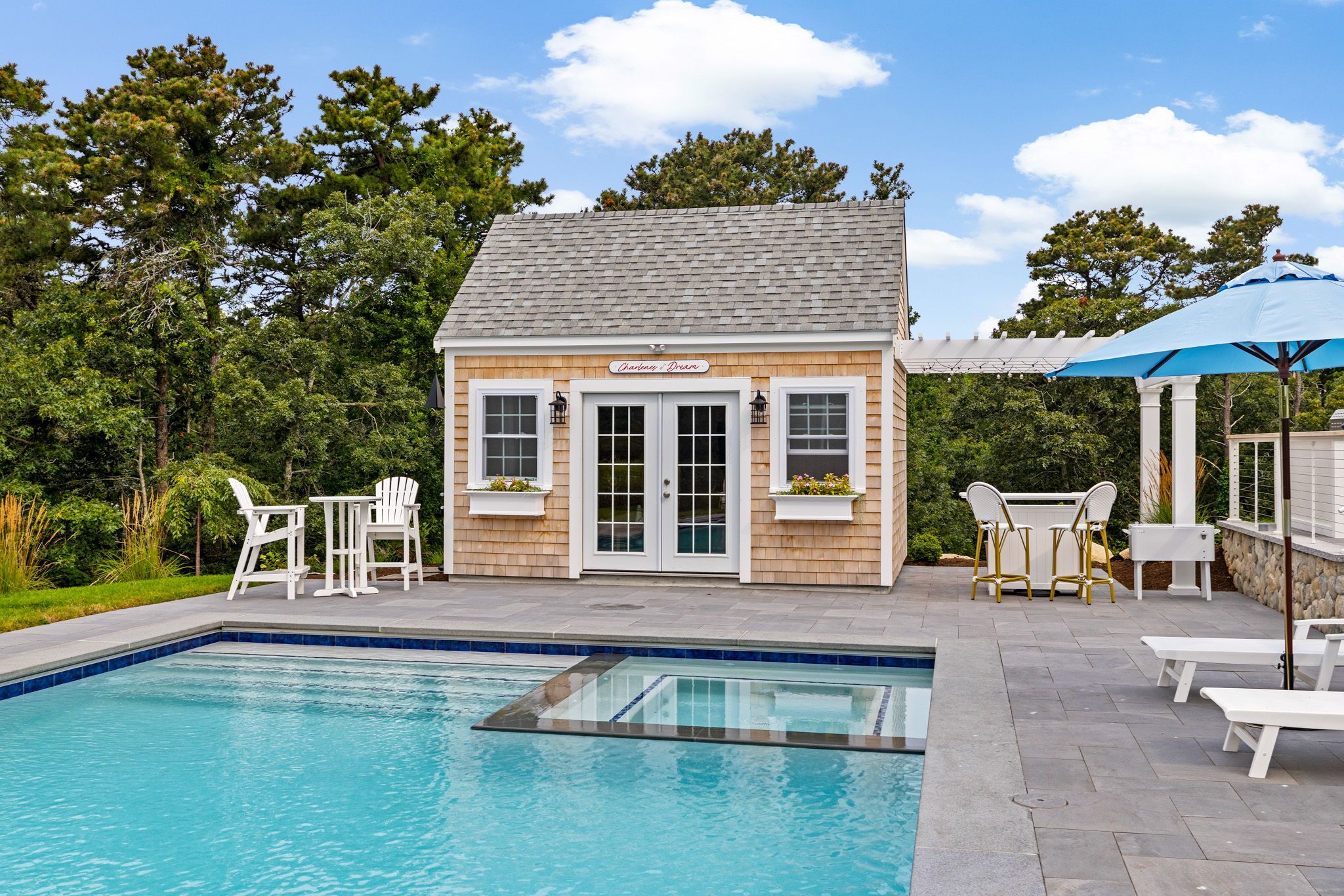 Expansive patio with poolside lounging, dining, and gathering areas.