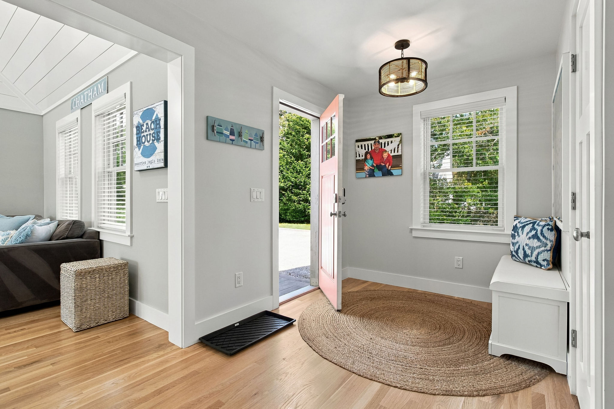 Bright coastal entryway with natural light, bench seating, and airy charm