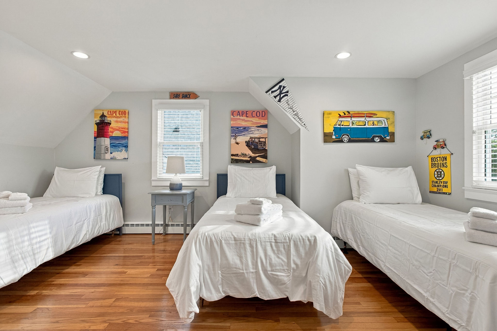 Bright triple-twin bedroom with coastal charm and sunny Cape Cod style