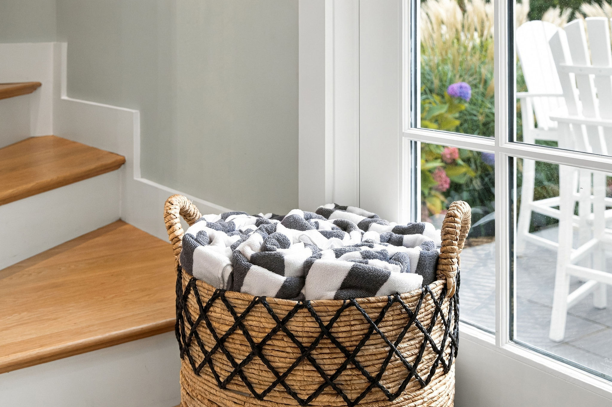 Cozy blanket basket by the window with garden views and natural light