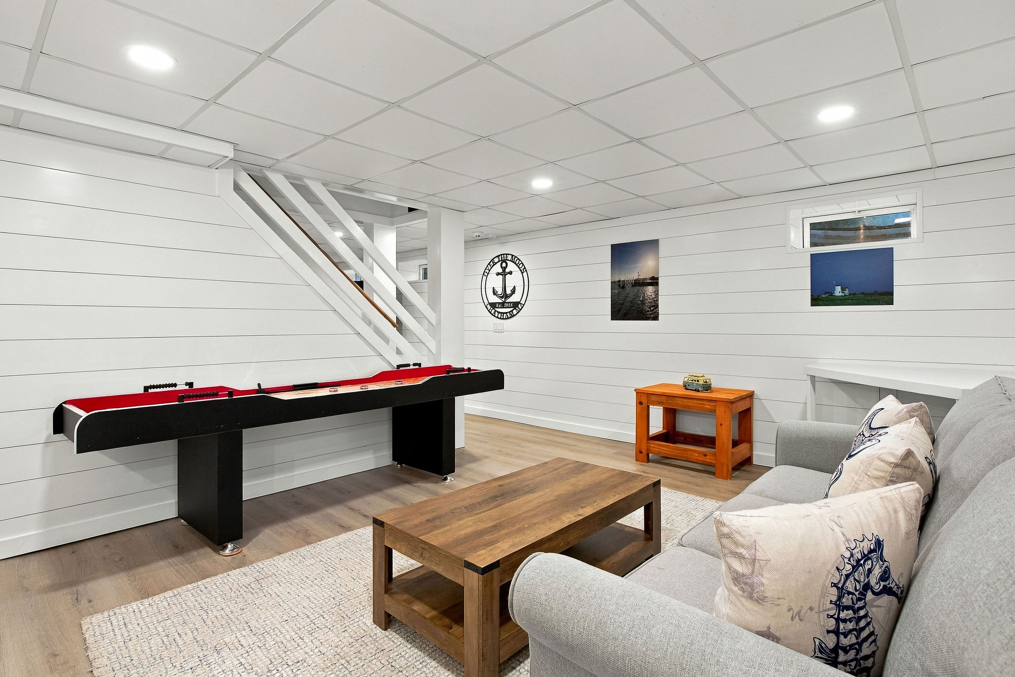 Cozy game room with sectional seating and a sleek pool table