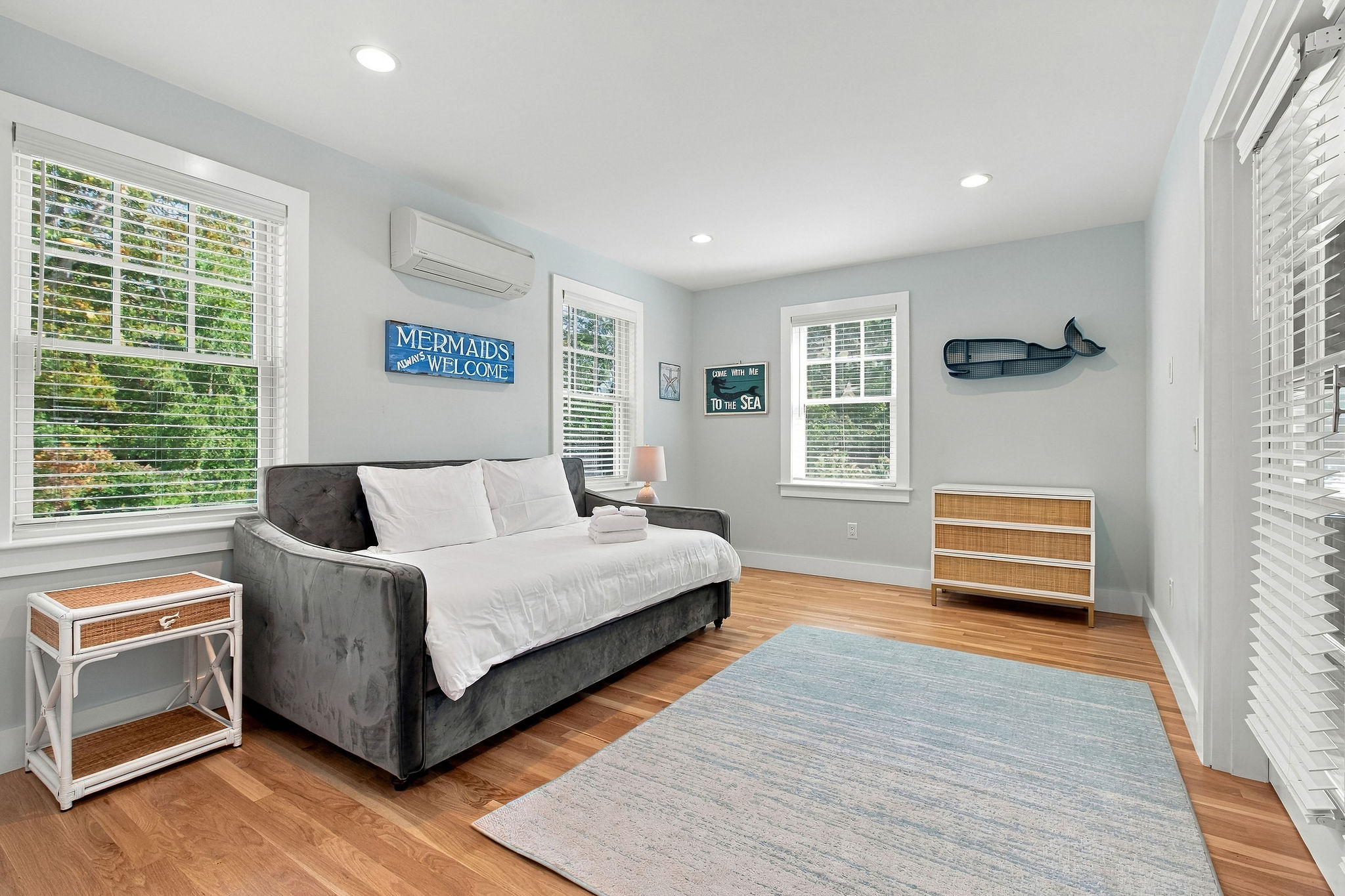 Bright coastal retreat with sunny windows and a cozy daybed