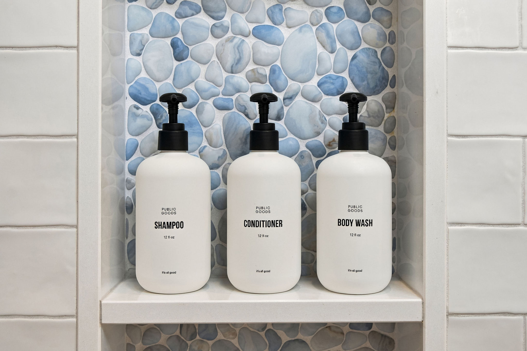 Spa-like shower niche with premium toiletries and stylish tile detail