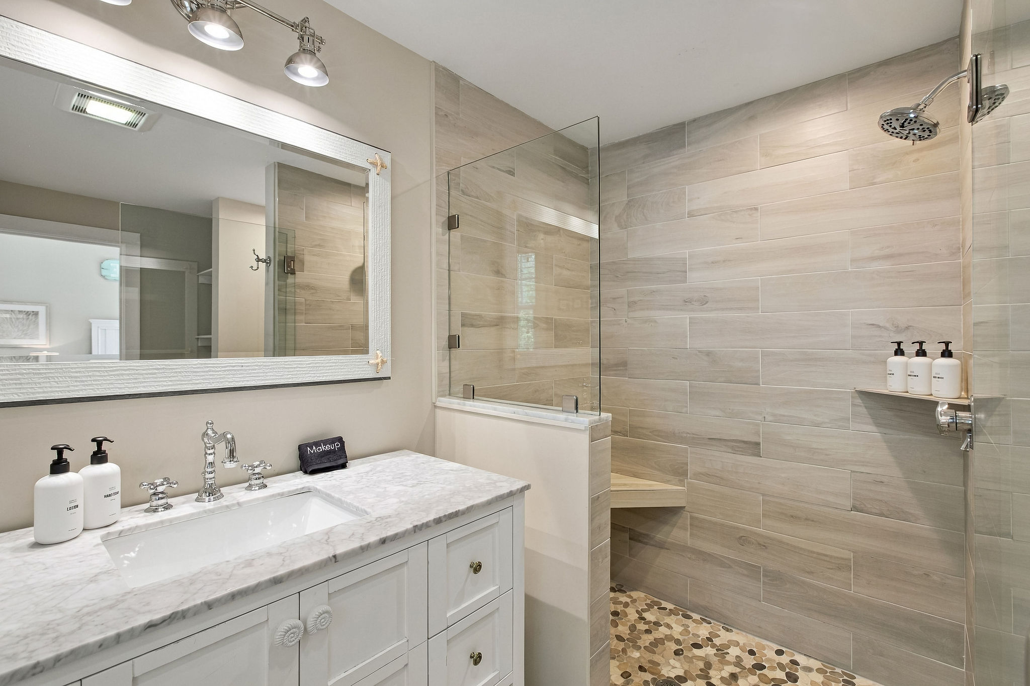 Spa-style bathroom with marble vanity and sleek walk-in shower
