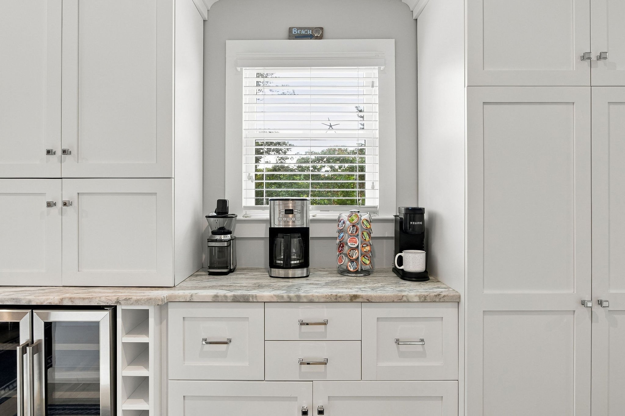 Bright coffee bar with beverage fridge and multiple brewing options