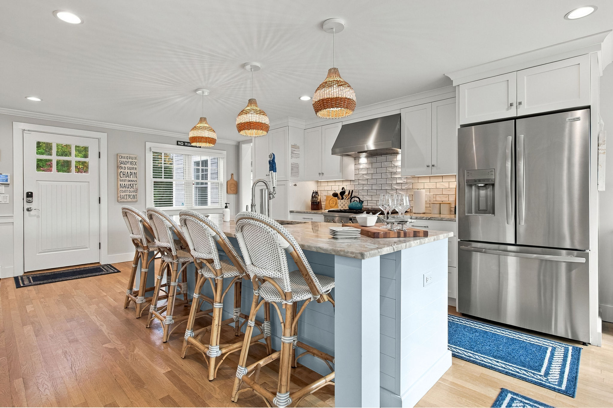 Bright coastal kitchen with island seating for four and stylish finishes