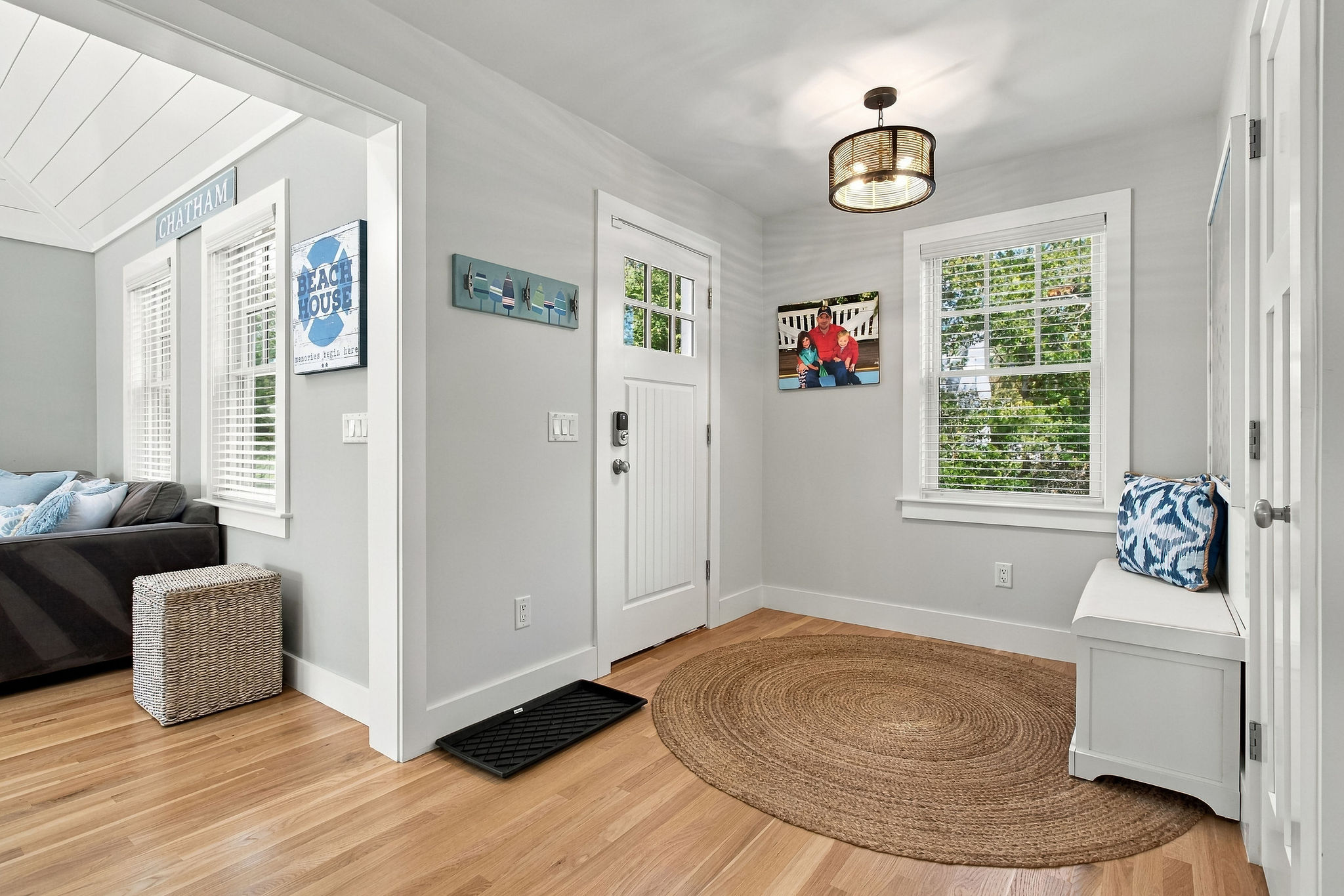 Bright coastal entryway with natural light and welcoming bench seating