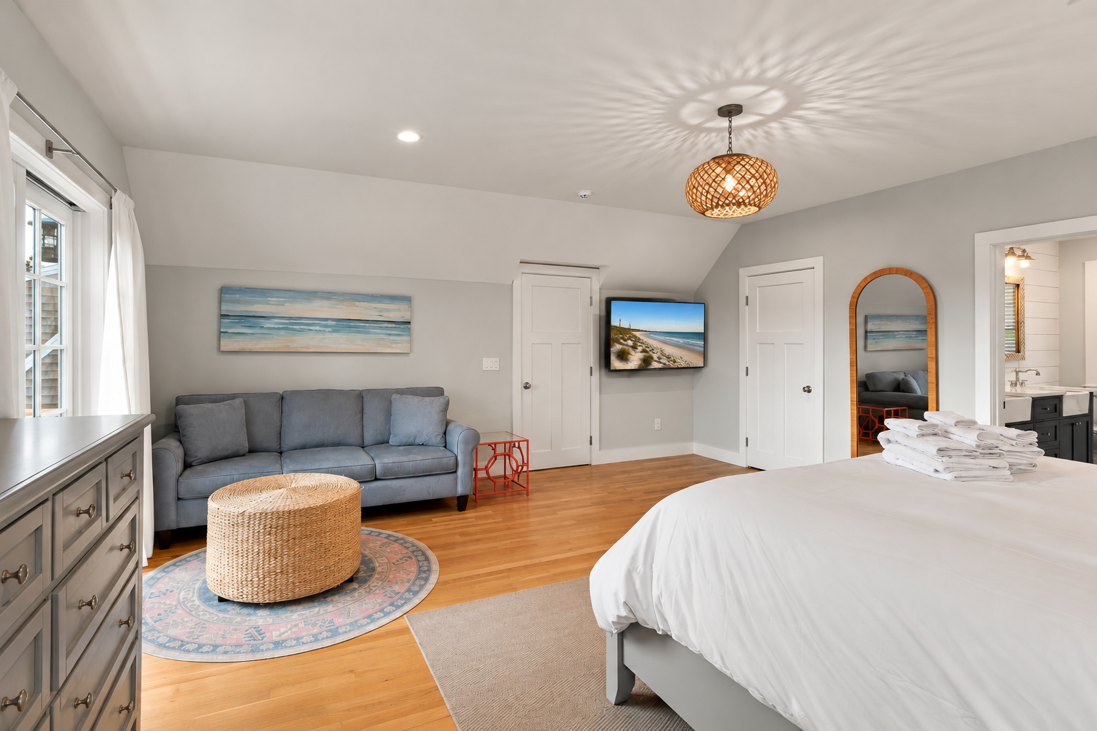Bright coastal bedroom suite with sofa lounge and ensuite bath