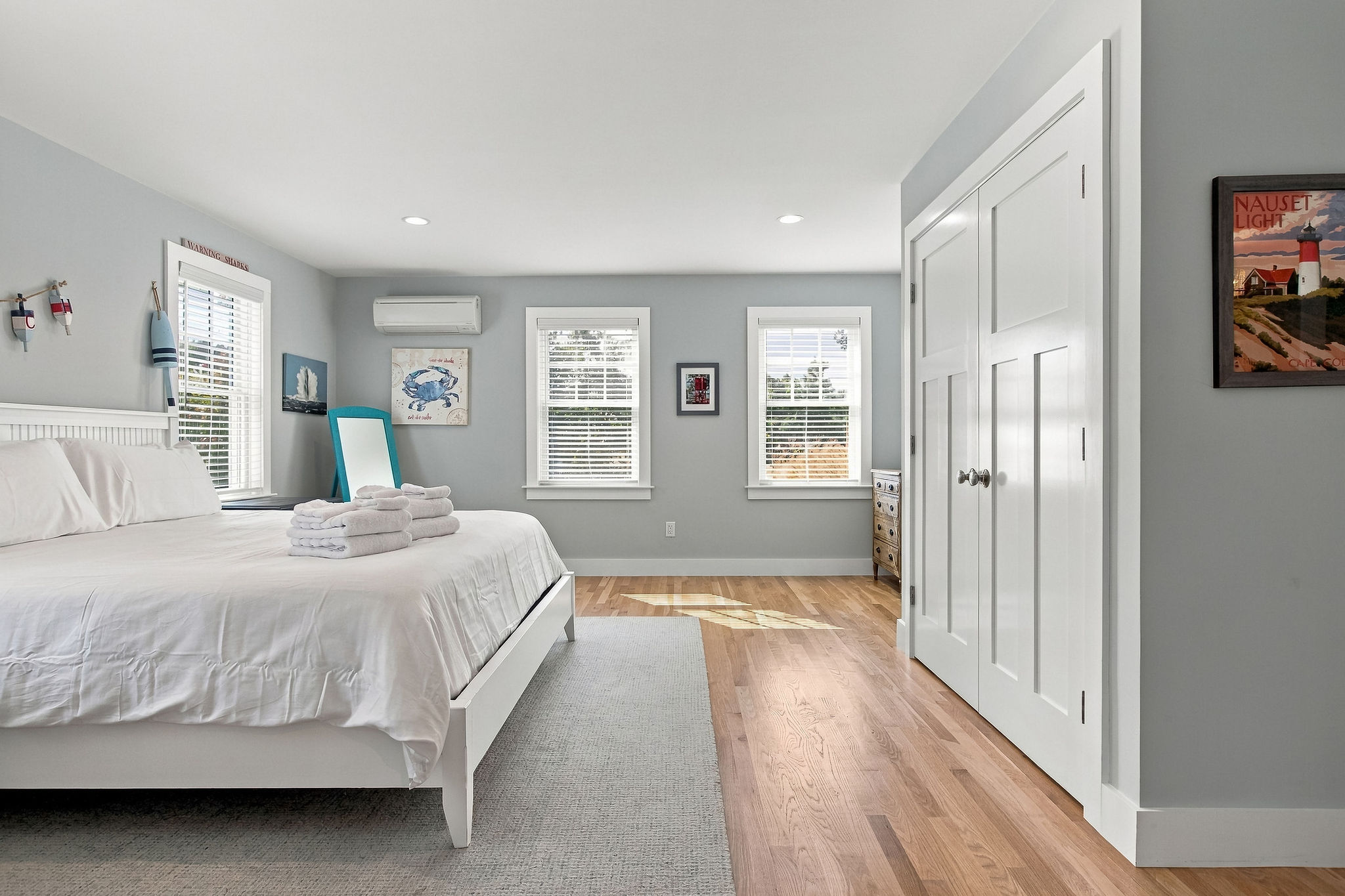 Bright coastal bedroom with natural light, AC, and spacious storage