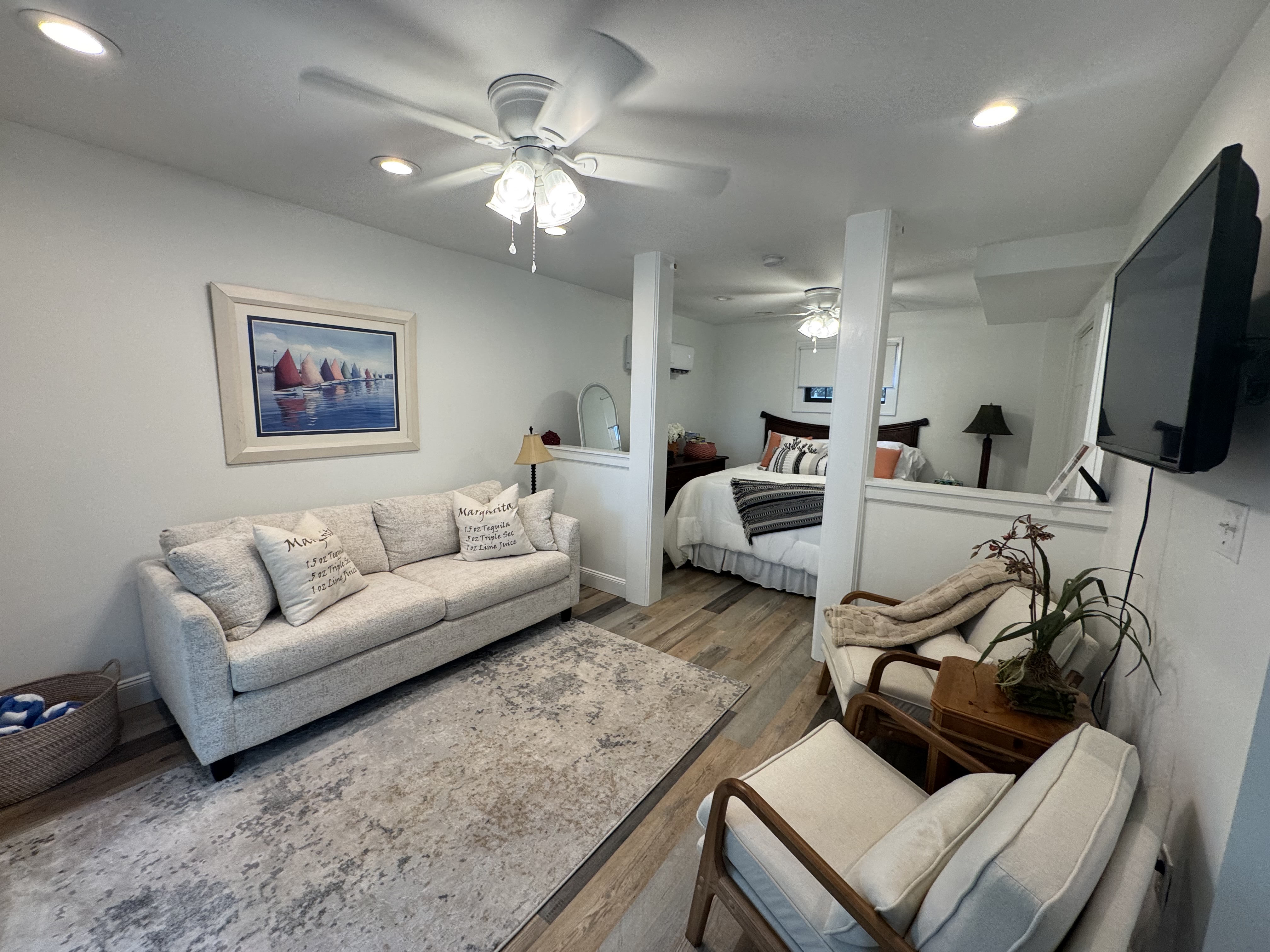 Lower Unit A - Bright open suite with cozy seating, TV, and semi-private sleeping area