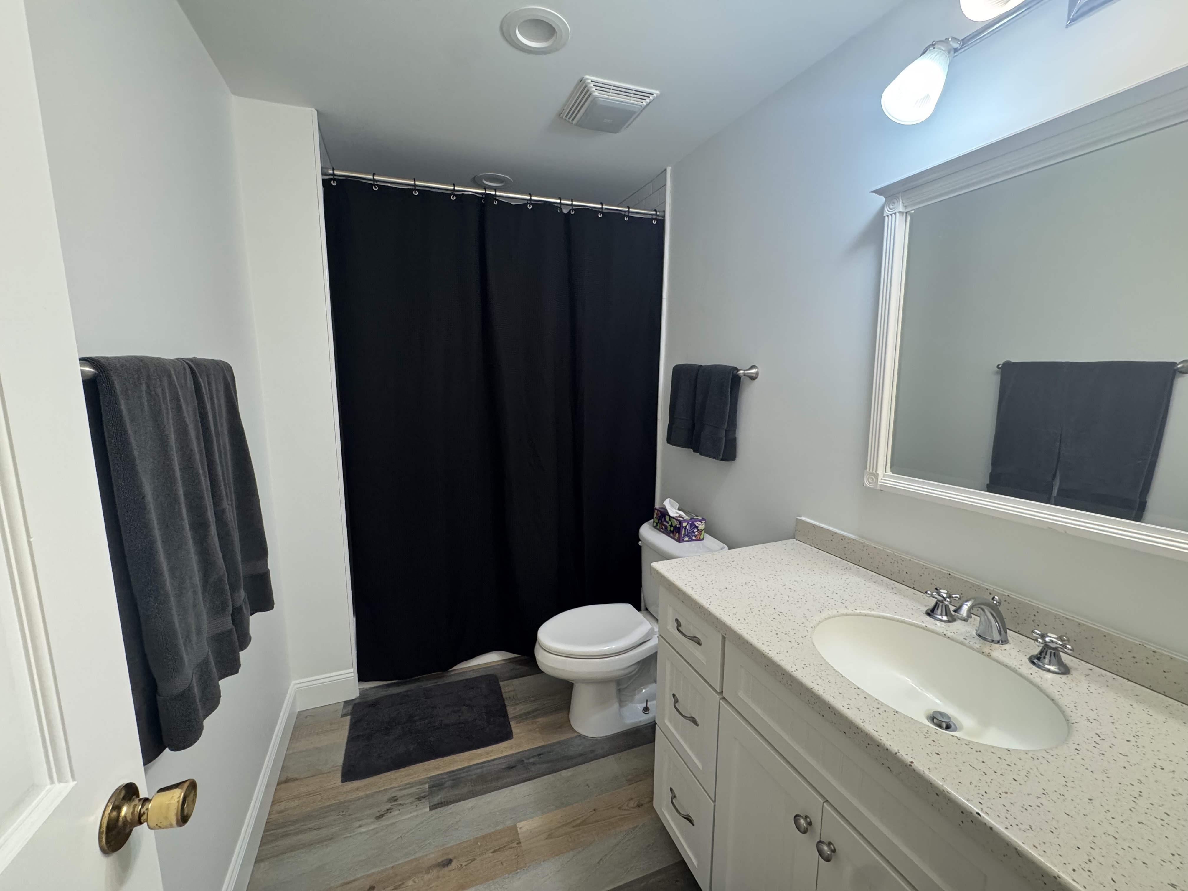 Bright modern bathroom with spacious vanity and full tub-shower combo