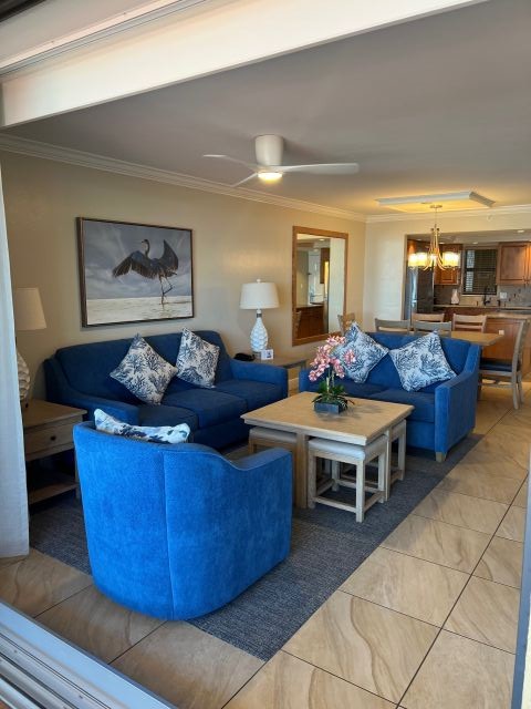 Bright open living space with stylish blue seating and dining area
