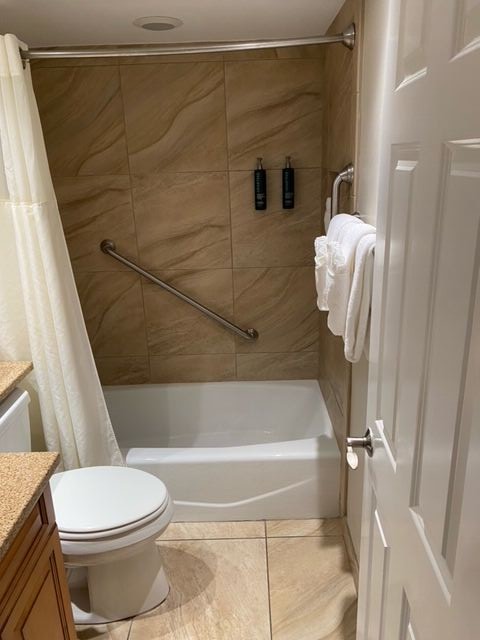 Clean bathroom with tiled tub-shower combo and thoughtful guest amenities