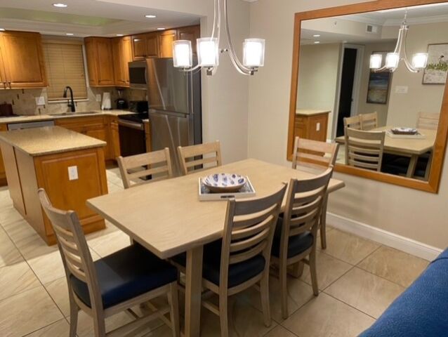 Open dining for 6 with modern lighting and a fully equipped kitchen