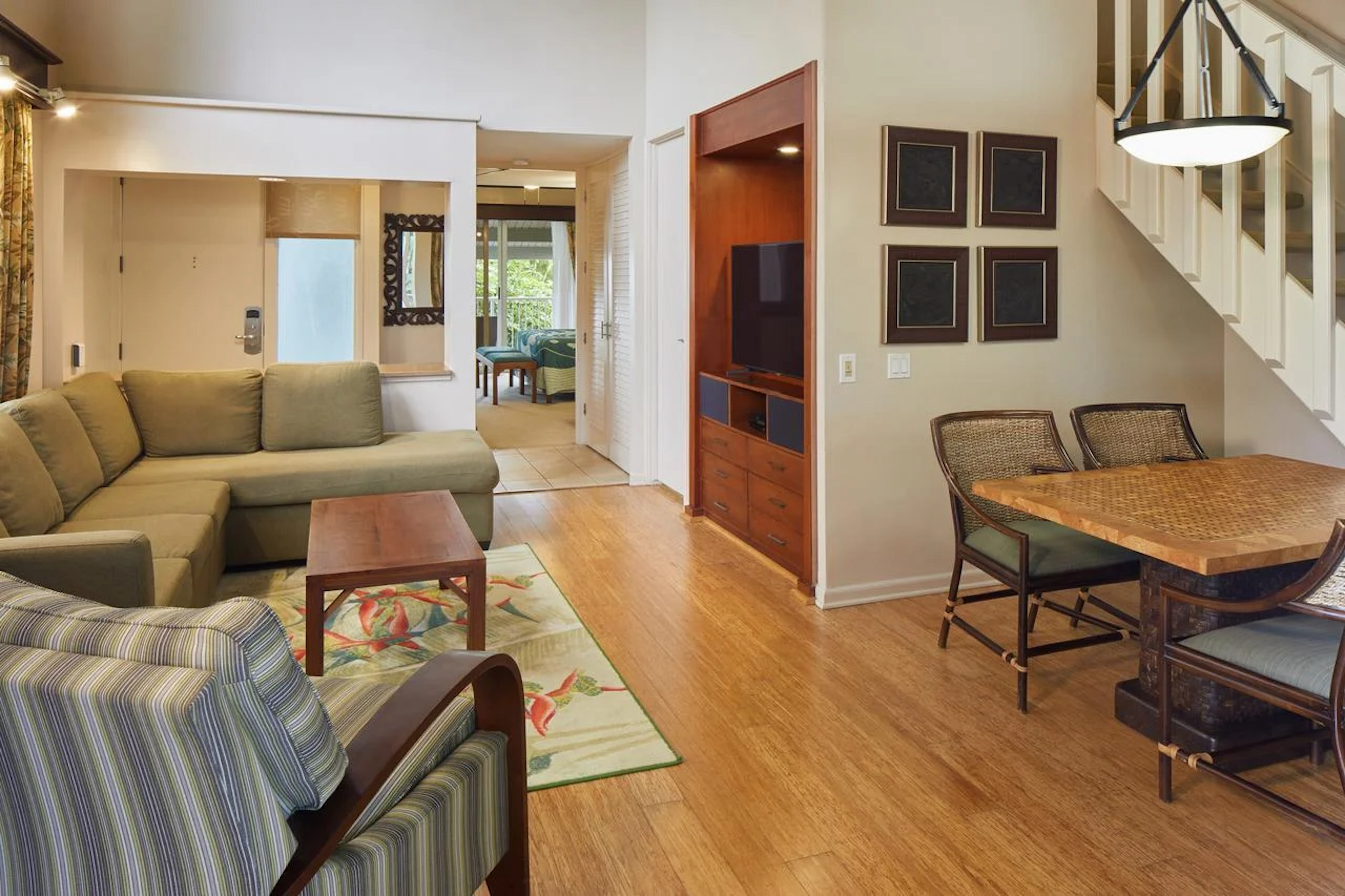 Bright open living area with comfy seating, dining nook, and built-in TV