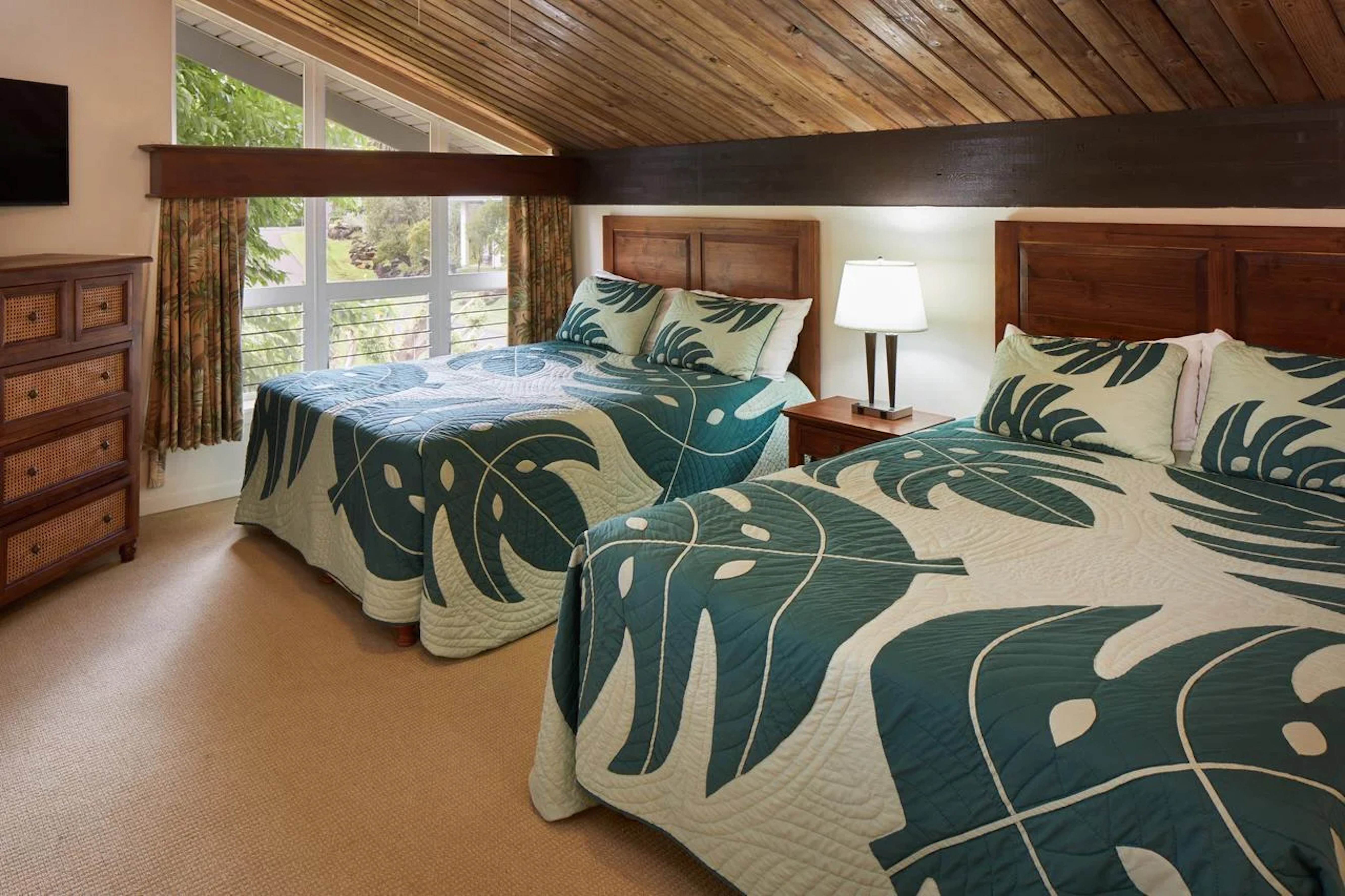 Bright double bedroom with tropical style and warm wood accents