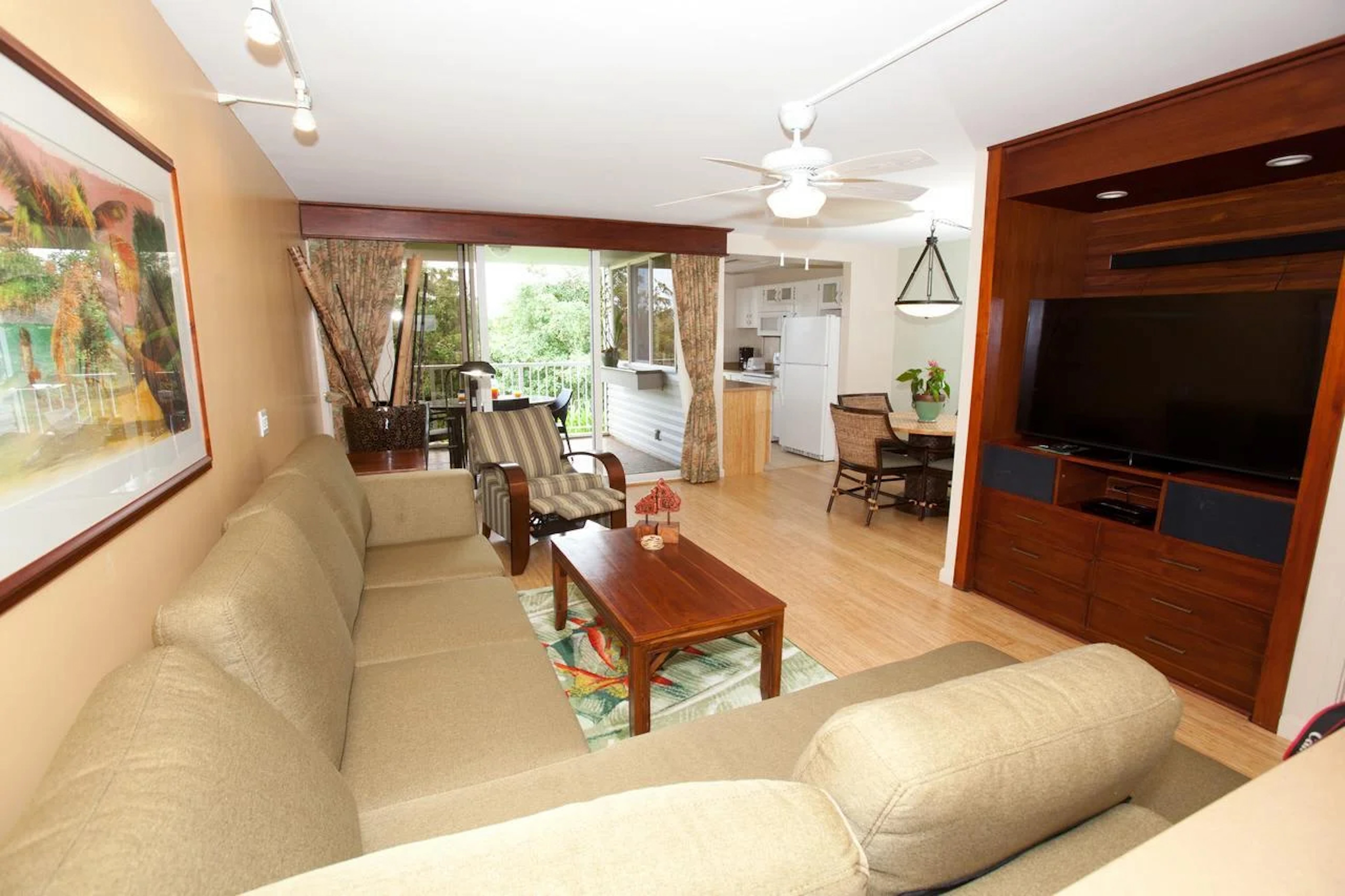 Bright open living area with balcony access, dining nook, and full kitchen