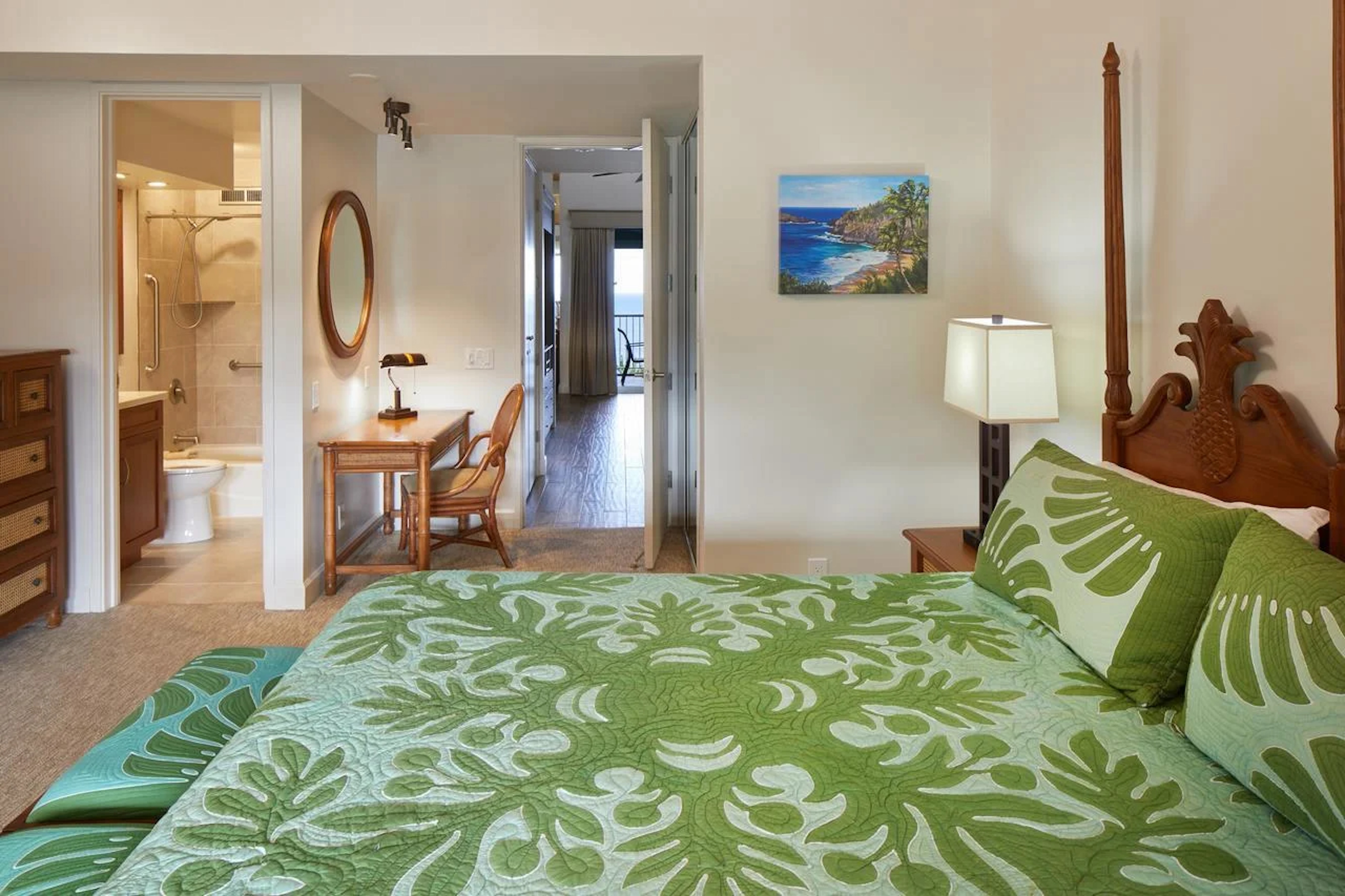 Tropical king suite with en suite bath and access toward an ocean-view lanai