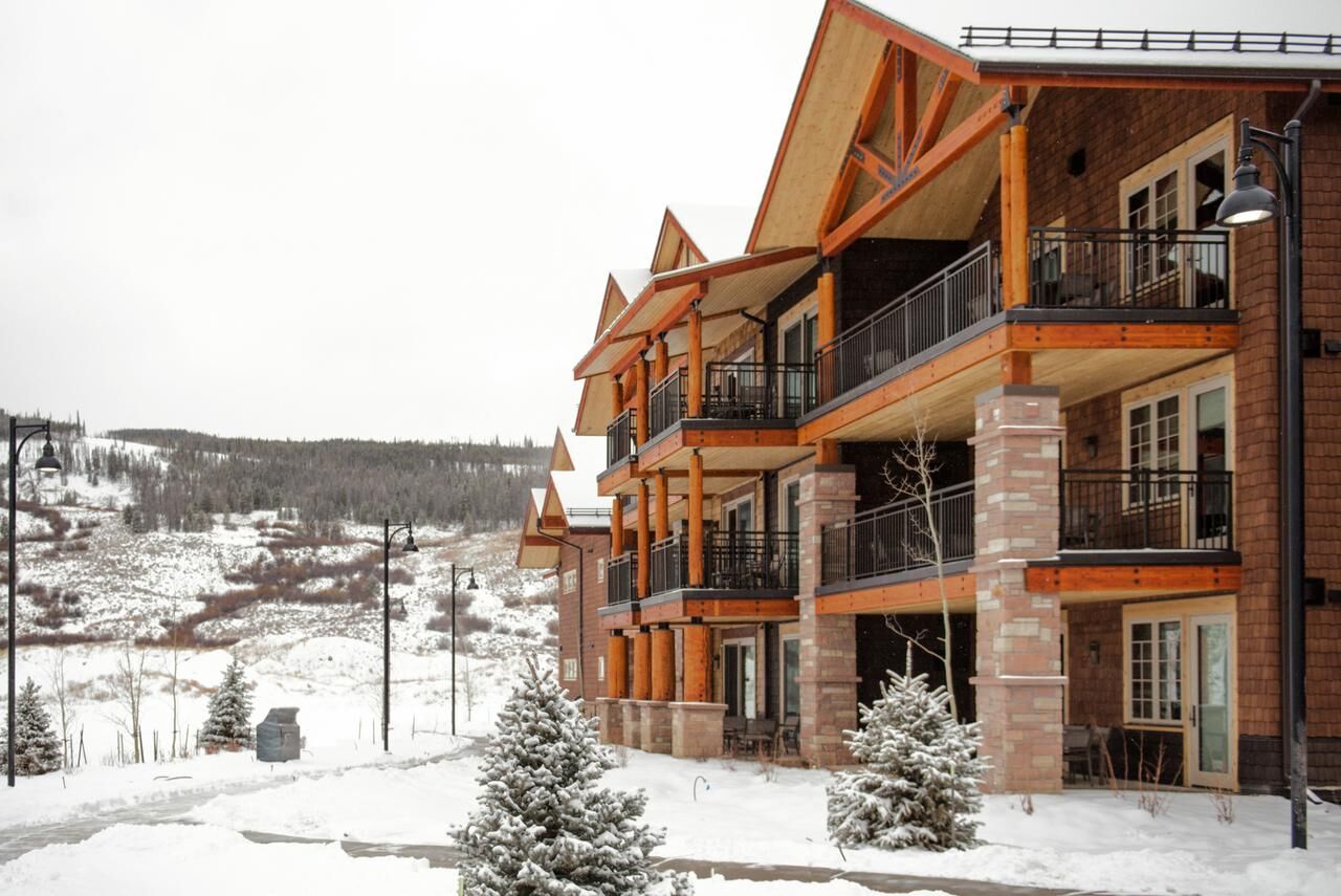 Snowy mountain lodge with spacious balconies and scenic alpine views