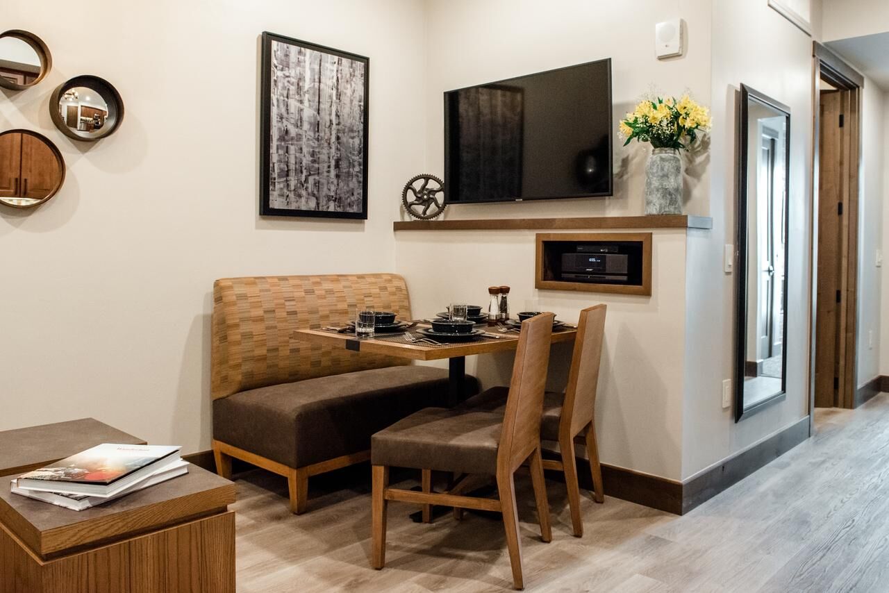 Cozy dining nook with banquette seating and wall-mounted TV