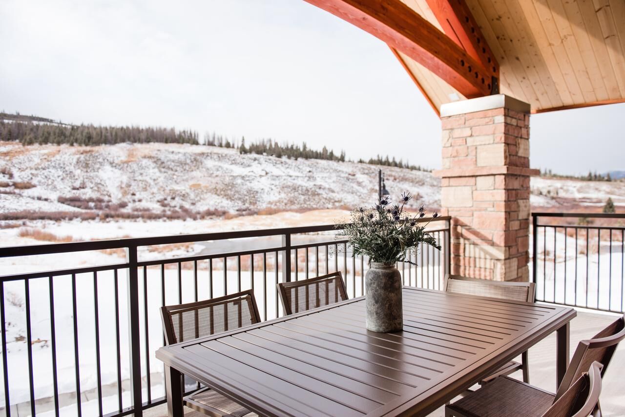 Covered balcony dining with serene snowy mountain-view scenery
