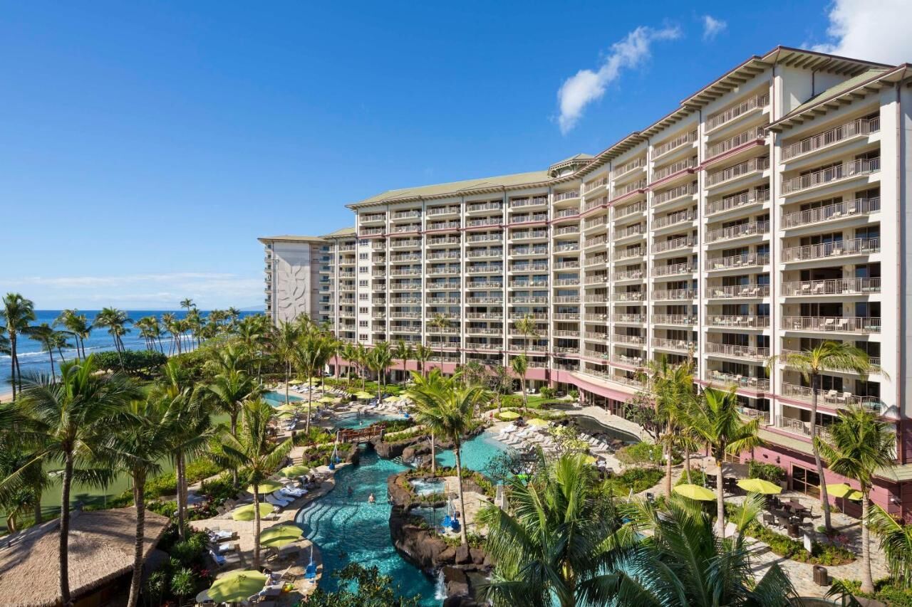 Oceanfront resort with tropical pools, palm trees, and stunning beach views