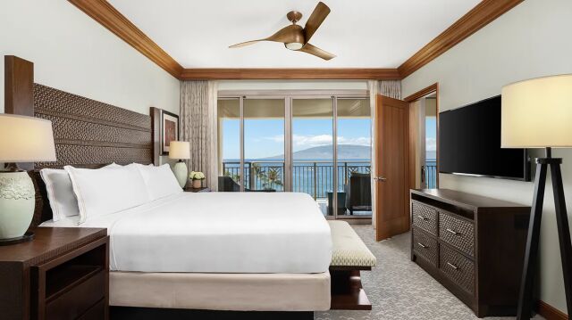 Serene king bedroom with private balcony and stunning ocean views