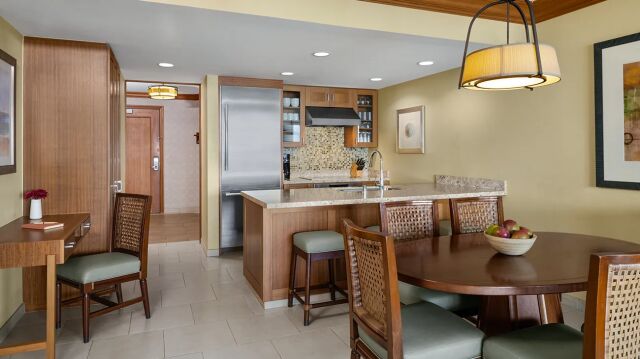 Spacious kitchen and dining area with breakfast bar and warm wood finishes
