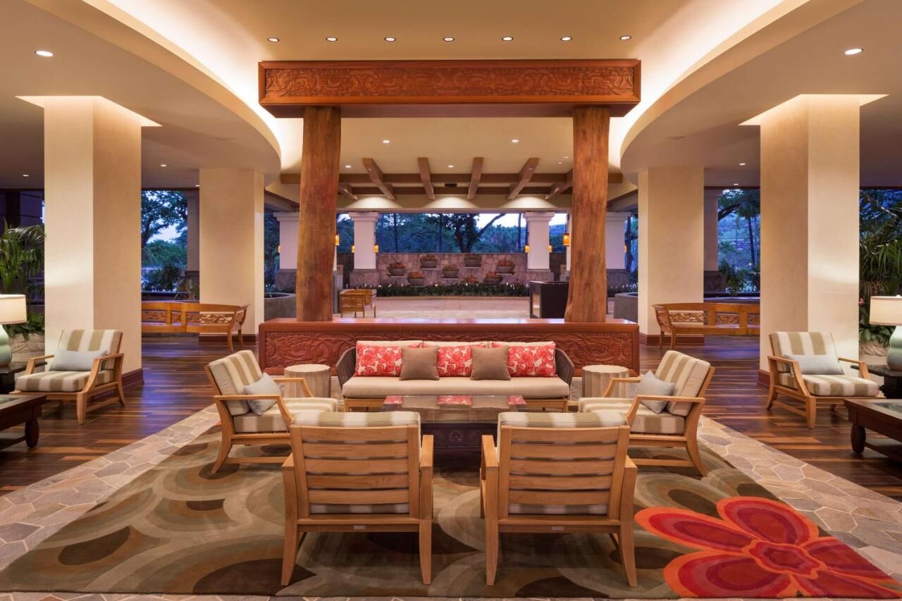 Elegant open-air lounge with warm lighting and inviting resort-style seating