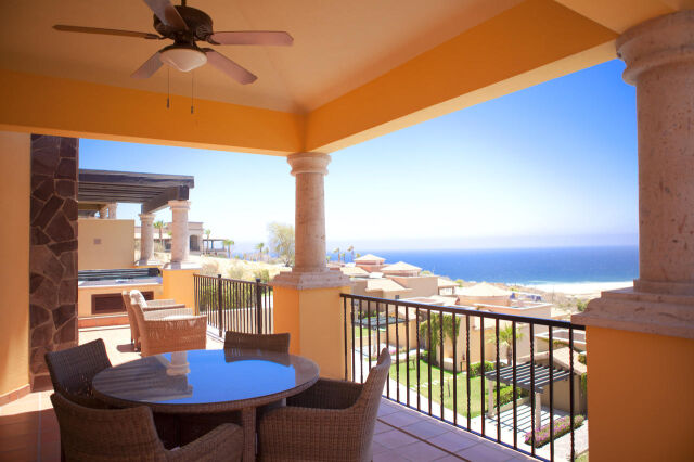 Covered ocean-view terrace with outdoor dining and coastal breezes