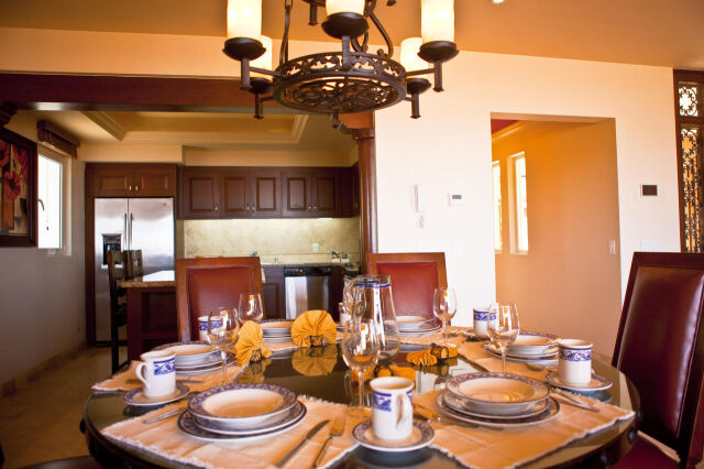 Elegant dining area with chandelier and open kitchen access