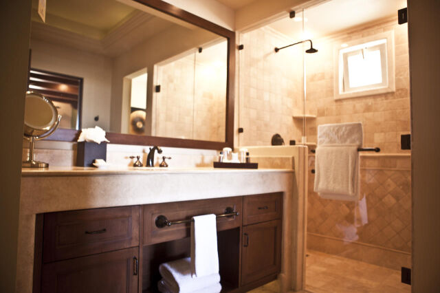 Spa-style bathroom with double vanity and elegant tiled walk-in shower
