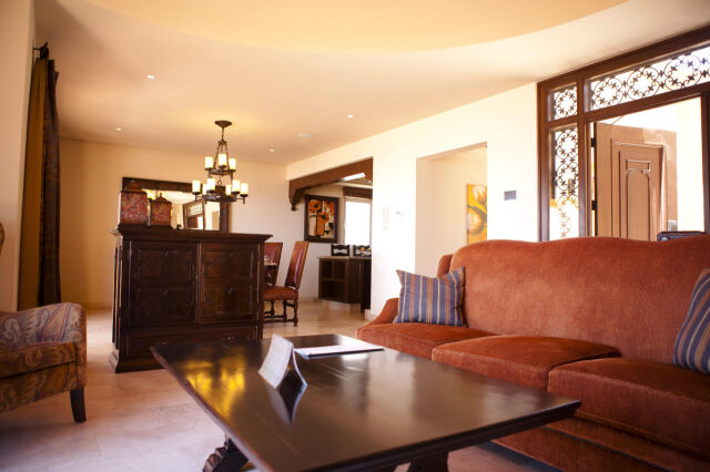 Spacious, elegant living area with warm lighting and open dining space