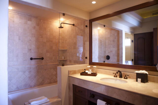 Elegant spa-style bathroom with stone tile shower and spacious vanity