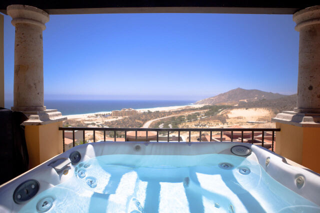Private balcony hot tub with sweeping ocean and desert hillside views