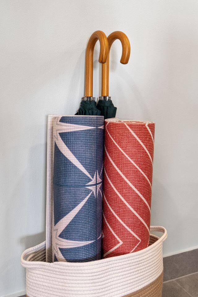 From relaxing on the sofa to preparing a meal in the connected kitchen, this open living space is designed for easygoing stays. You’ll also find mats and umbrellas tucked neatly into a convenient corner for your use.