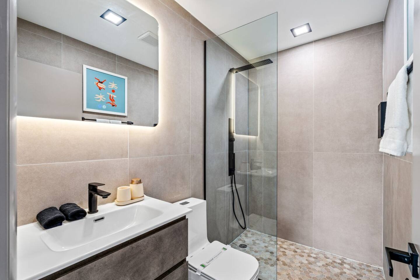 This bathroom is an ensuite to the King bedroom including modern features, a walk-in shower and luxury rain head + hose shower heads for your convenience.