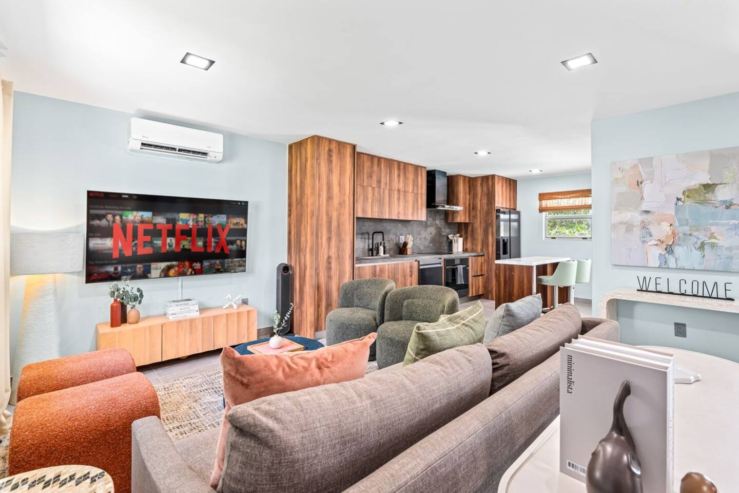 Make yourself at home in this inviting living room, featuring comfortable seating and a few bright touches of color. The open layout connects naturally with the kitchen, creating a shared space for everyone to enjoy.