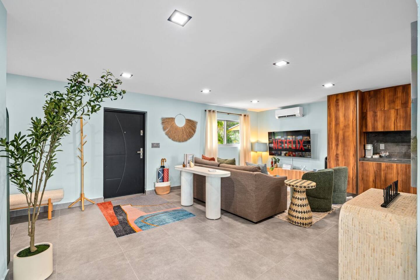 Comfortable, bright, and easygoing, this living room offers plenty of space to relax and gather. Its open connection to the kitchen keeps the space feeling welcoming and connected.