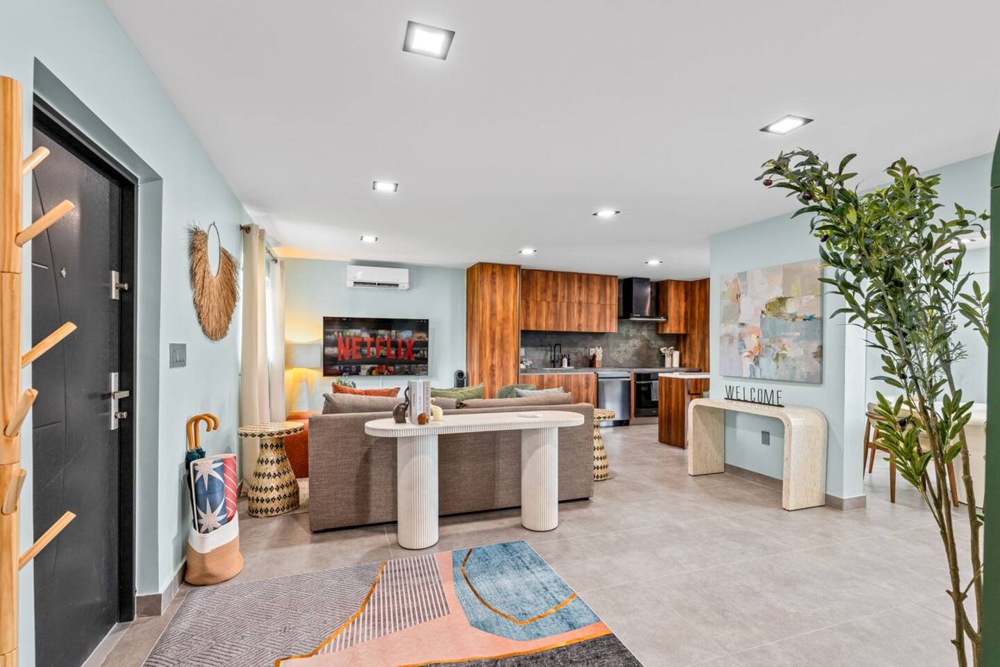 Whether you’re settling in after a day out or enjoying a meal together, the living room offers a comfortable place to unwind. Bright accents and an open connection to the kitchen give the space a welcoming feel.