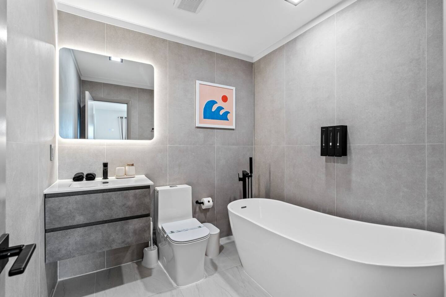 A bright, modern bathroom featuring a relaxing bathtub, shower, vanity, and everything you need to freshen up.