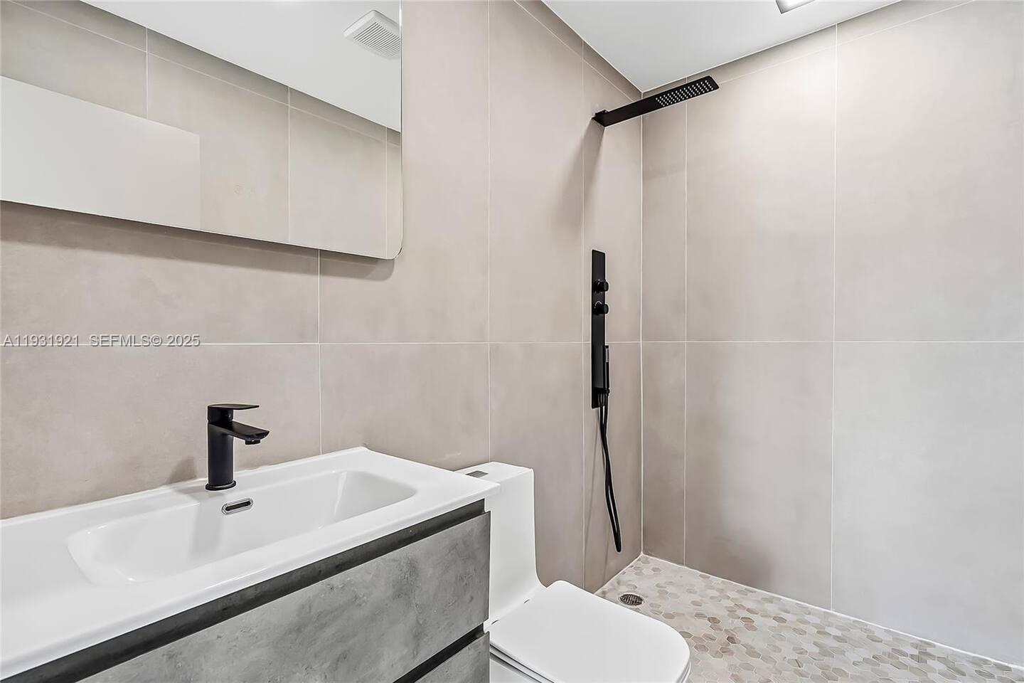 A bright and modern bathroom with a shower, vanity, and everything you need to freshen up and relax.