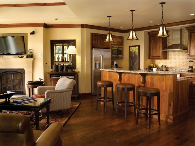 Cozy open living space with gourmet kitchen, fireplace, and bar seating