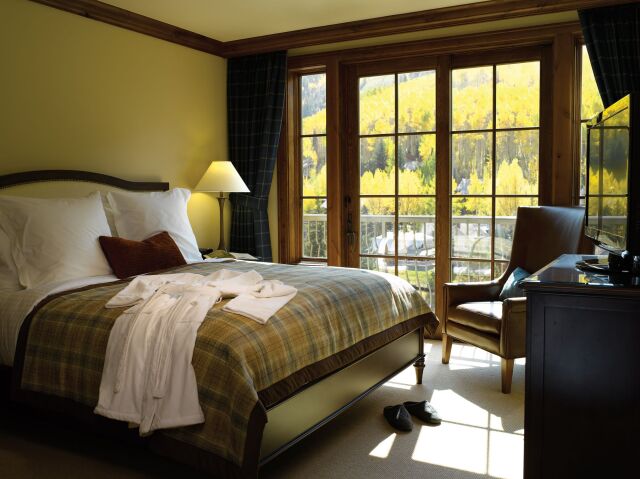 Cozy bedroom with balcony and stunning mountain-view windows