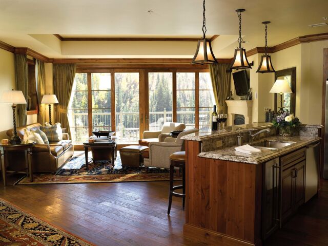 Cozy mountain-view living room with fireplace and granite kitchen island
