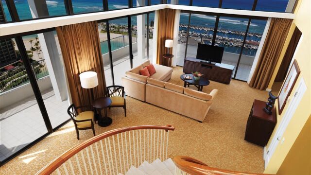 Bright two-story living room with balcony and stunning ocean views