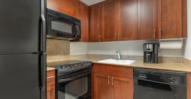 Fully equipped kitchen with warm wood cabinets and modern appliances