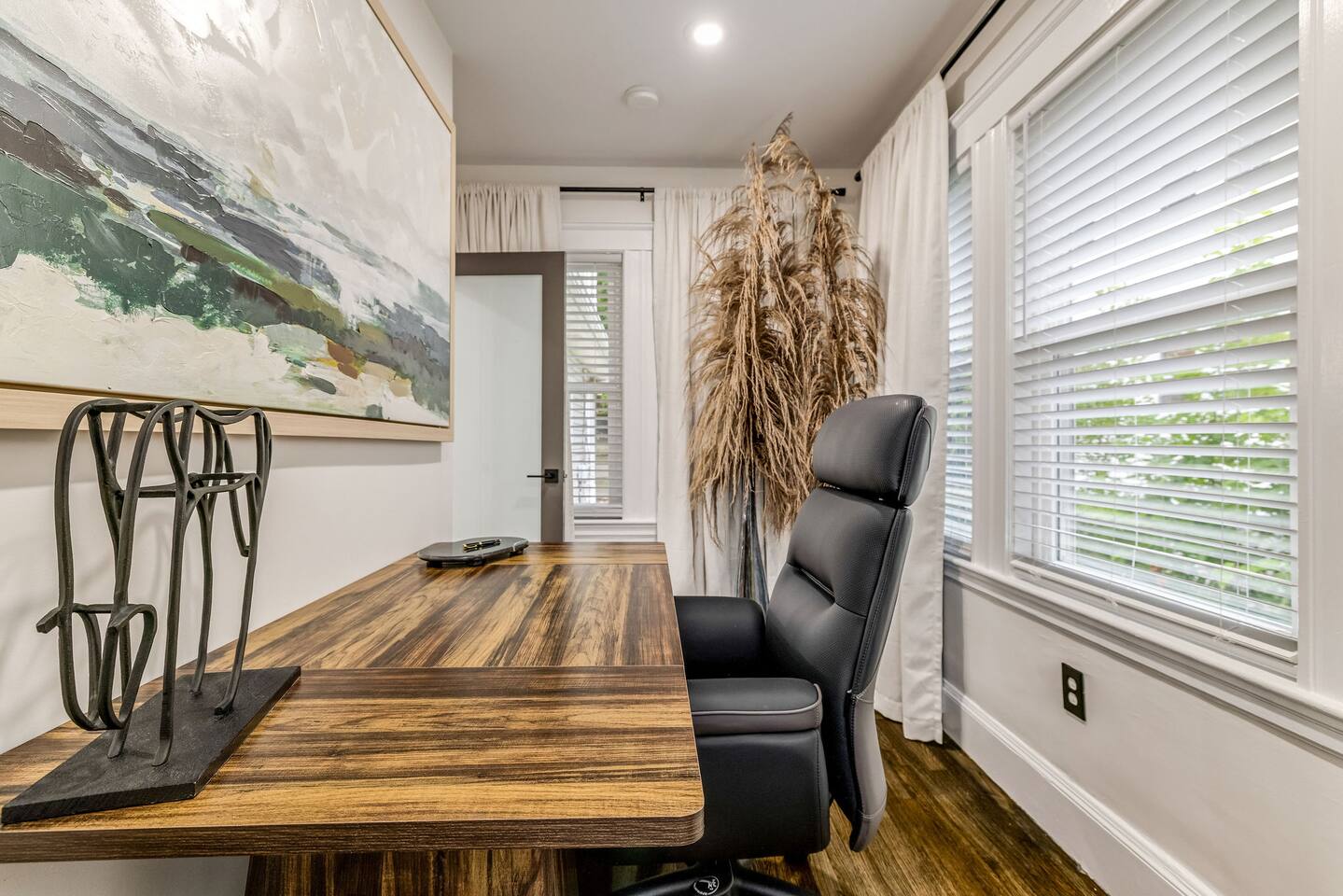 Dedicated workspace with a spacious desk, comfortable office chair, and abundant natural light.