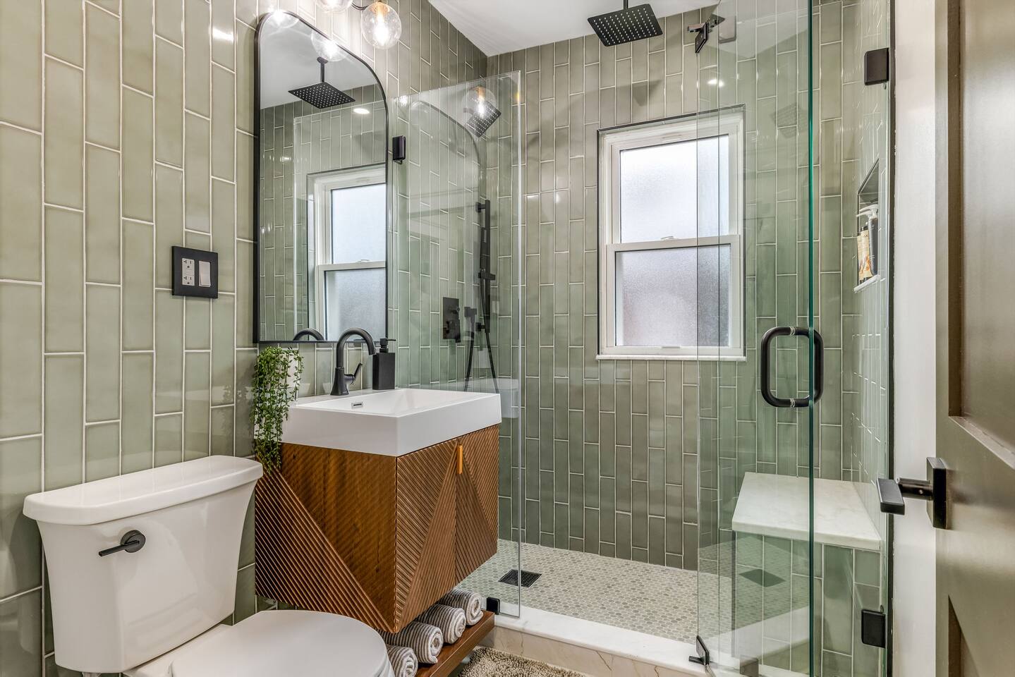 Modern full bathroom with a walk-in glass shower and premium finishes.